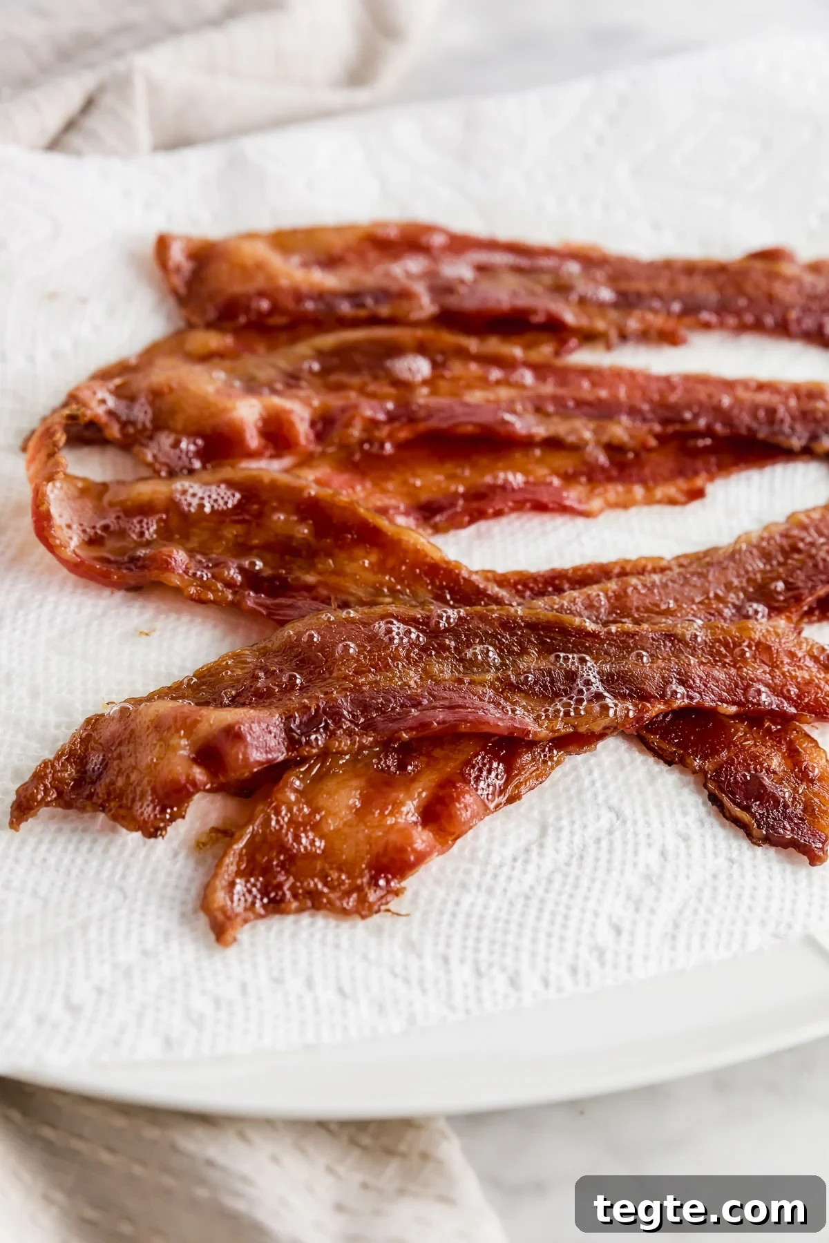 Crispy Oven-Baked Bacon: Foolproof Method for Perfect Slices 5 Baked bacon straight from the oven on a plate.