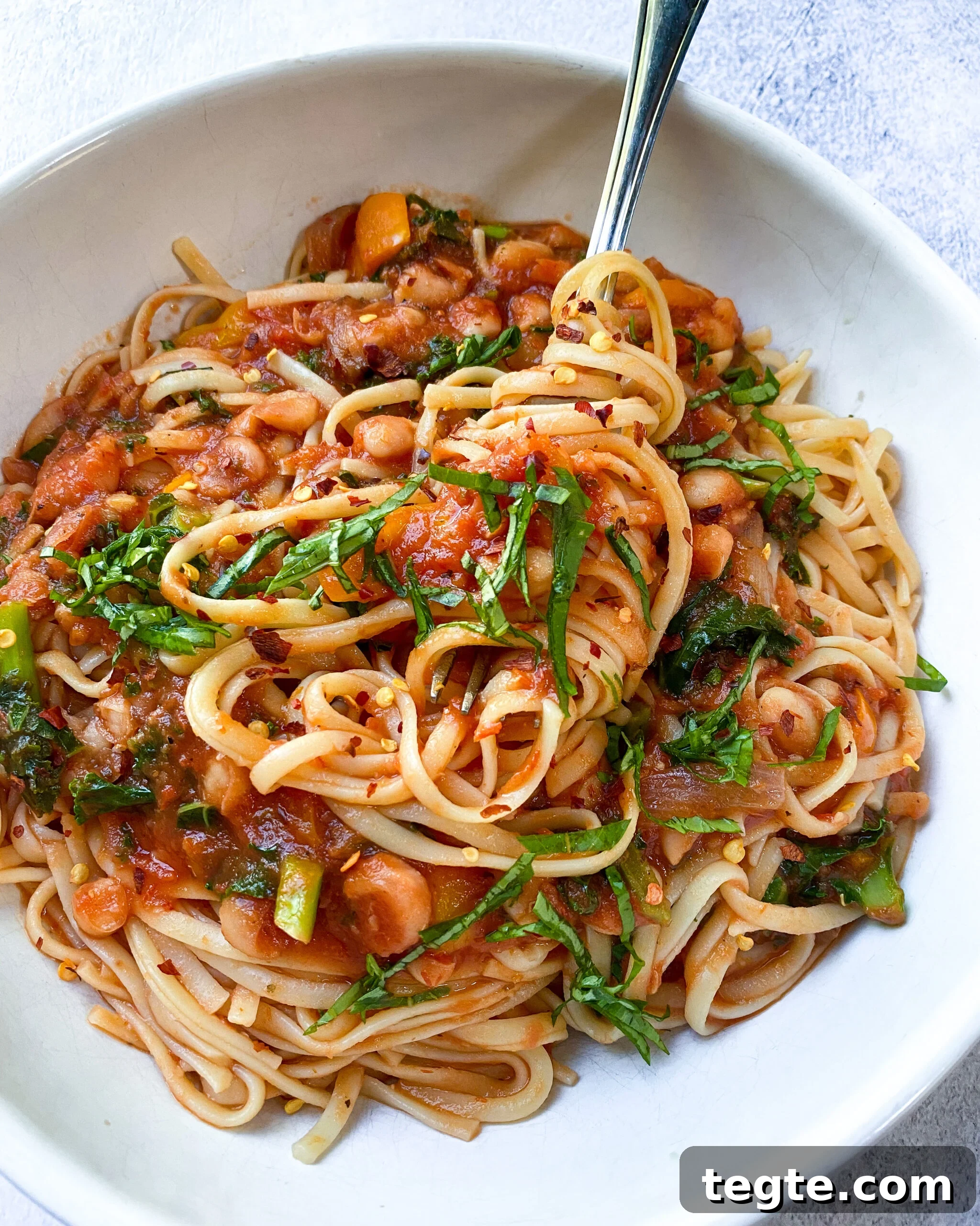 26 Cozy Vegan Dinners to Warm Your Winter Nights 26 image white bean and kale linguine in a white bowl.