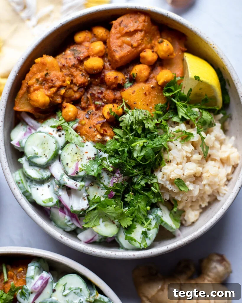 26 Cozy Vegan Dinners to Warm Your Winter Nights 8 Overhead view of vegan chickpea and potato curry with rice and cucumber salad