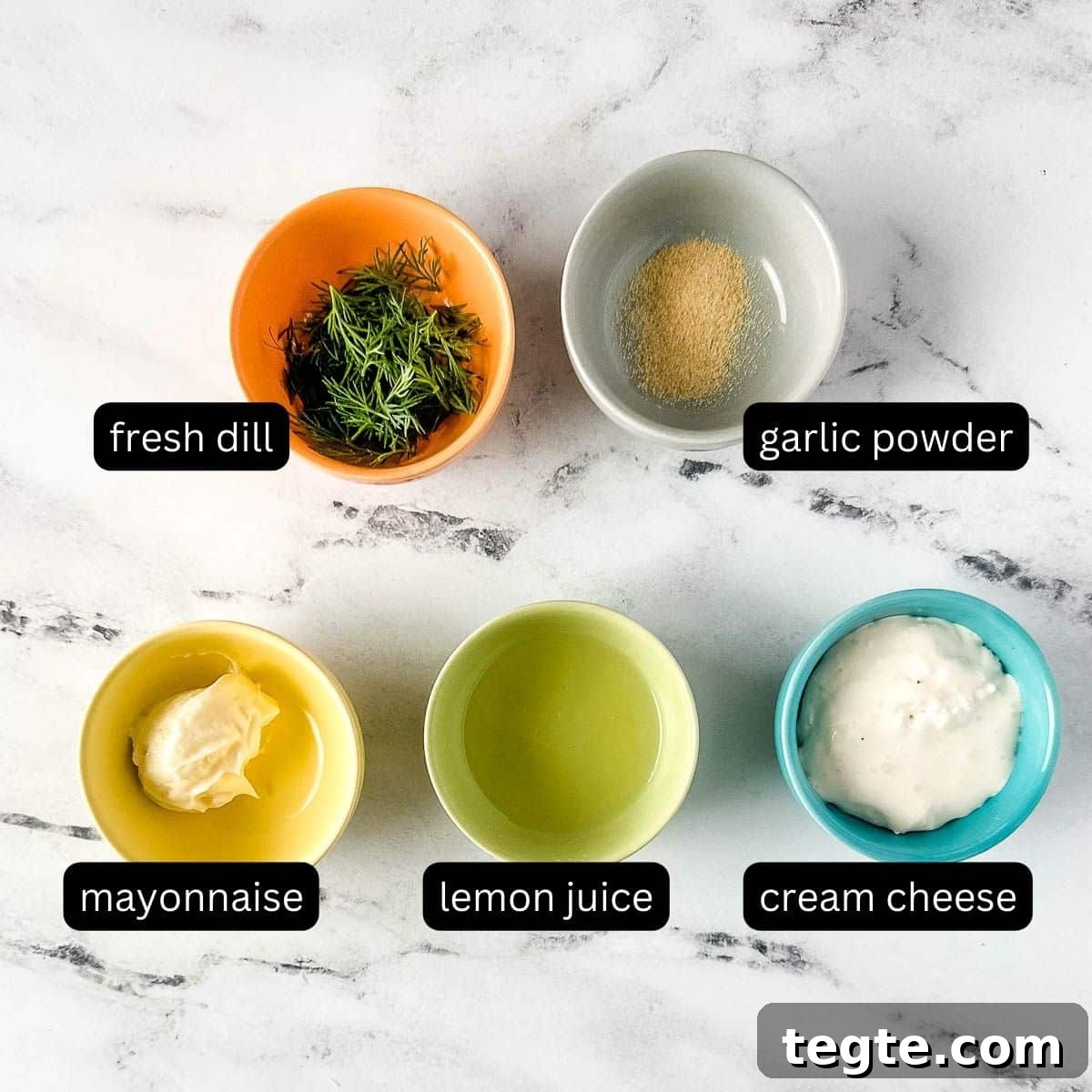 Creamy Dill Sauce for Fish, Salmon, and Vegetables 3 labeled ingredients for dill sauce on a white marble counter.