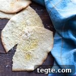 Parmesan Piadine: Crispy Italian Parmesan Flatbreads Recipe 3 Slices of piadine flatbreads topped with olive oil and Parmesan cheese.