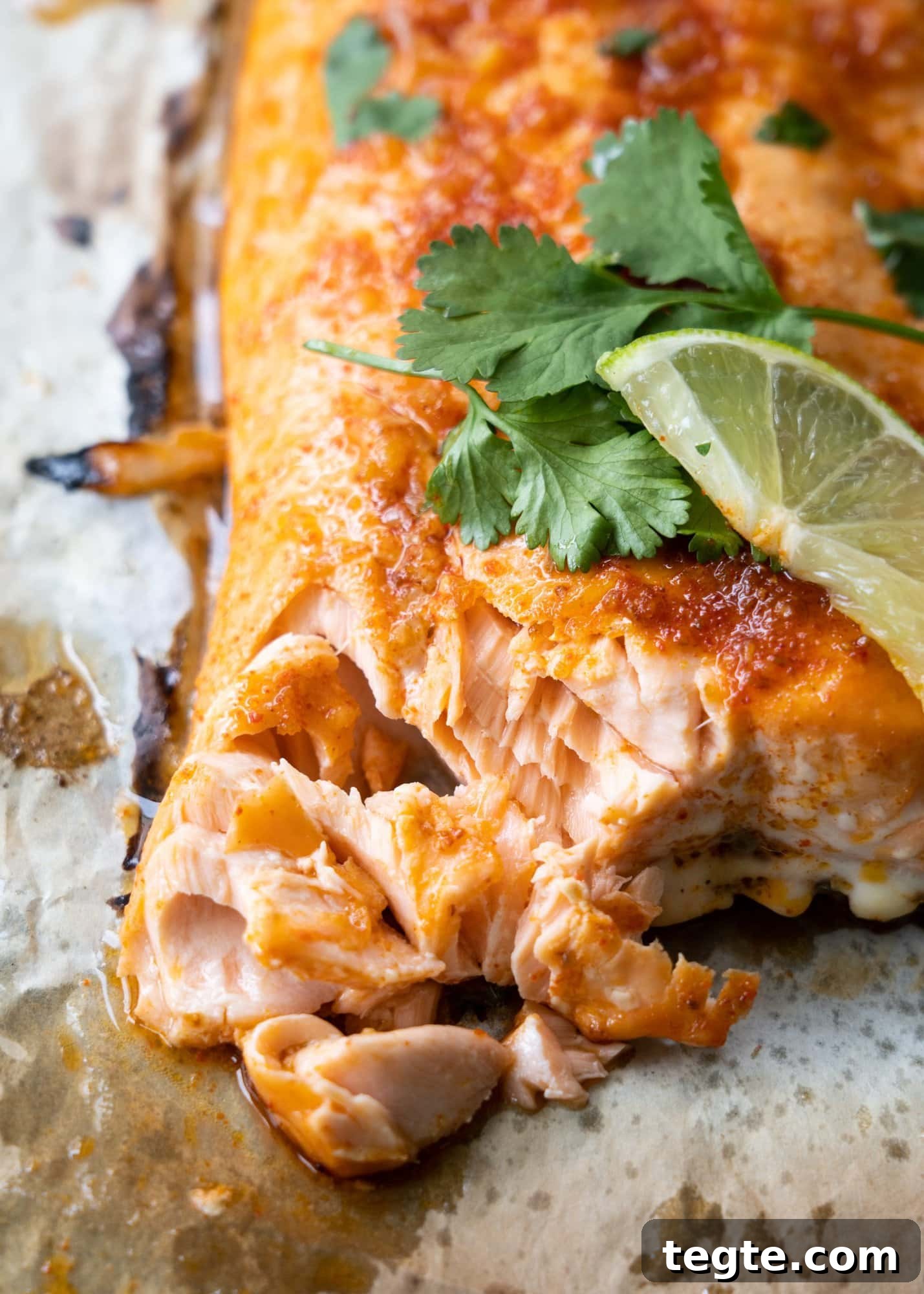 Chili-Lime Marinated Baked Salmon Recipe 3 Baked salmon has tender and flaky meat inside as shown in the image with celery and a lime slice.