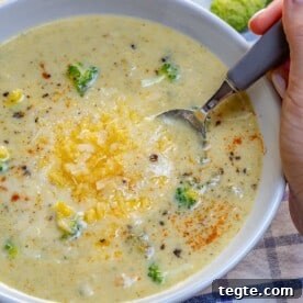 Over 20 St. Patrick’s Day Recipes for Festive Celebrations 23 hand holding spoon in a bowl of Broccoli Cheddar Soup