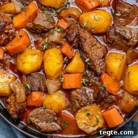 Over 20 St. Patrick’s Day Recipes for Festive Celebrations 5 beef stew in a red and black skillet with potatoes and carrots.