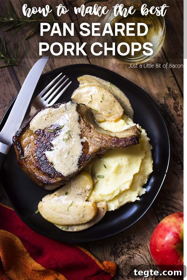 Pork chop and apple cream sauce on a black plate with text overlay - Pan Seared Pork Chops.