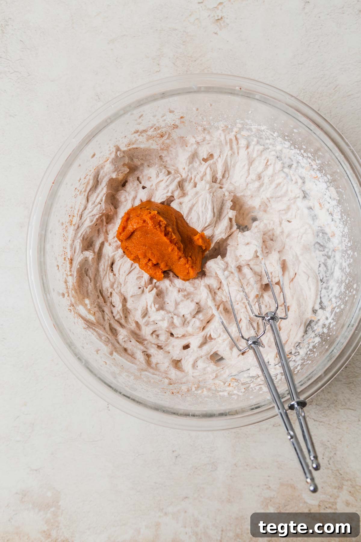 Pumpkin-Spiced Whipped Cream Recipe for Fall Desserts 6 whipped c ream with pumpkin puree.