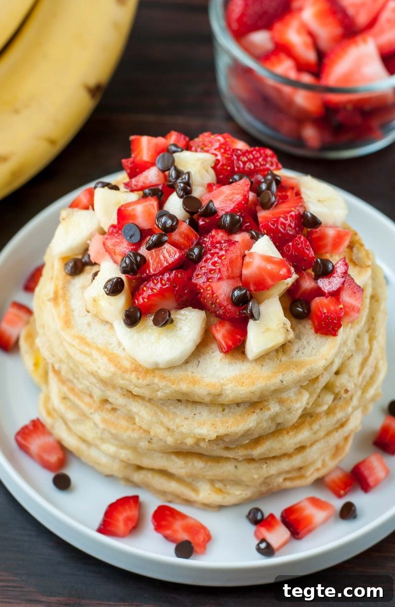 Banana Split Pancake Recipe: Fluffy Pancakes with Strawberry, Pineapple & Chocolate 3 Perfectly fluffy pancakes topped with banana, strawberries, and a kiss of dark chocolate chips, these Banana Split Pancakes are a healthy spin on dessert pancakes!