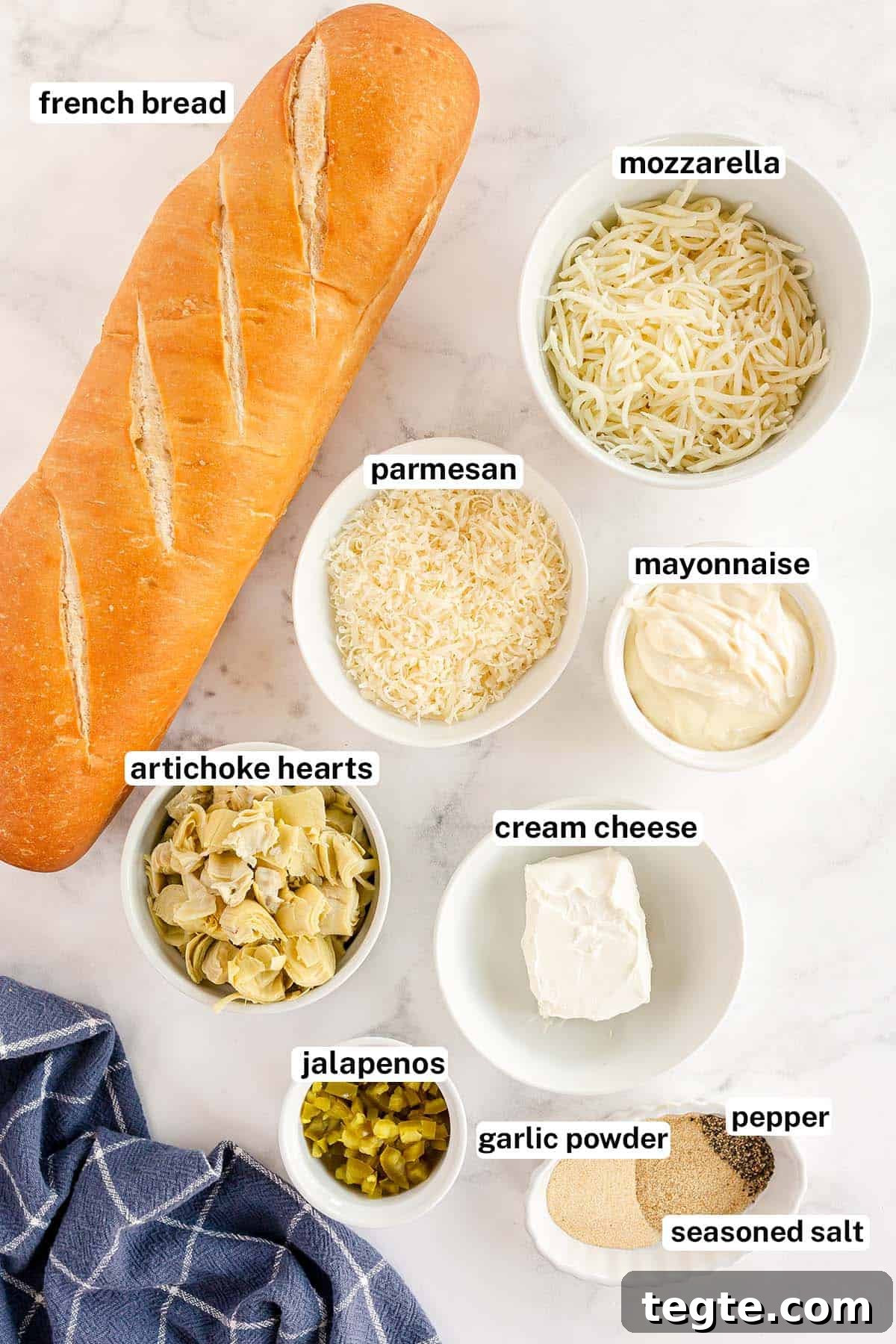 Cheesy Artichoke Pull-Apart Bread for Parties and Snacks 4 The ingredients for Cheesy Artichoke Bread with overlay text.