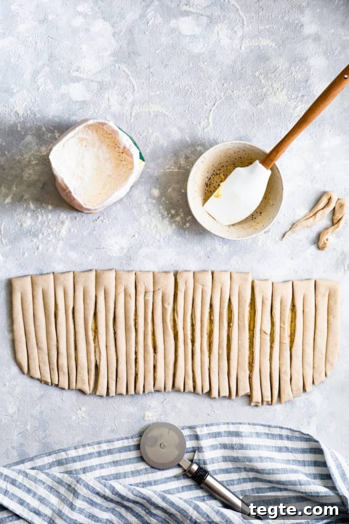Authentic Swedish Cardamom Buns (Kardemummabullar) Recipe 10 top view of a dough sliced into strips