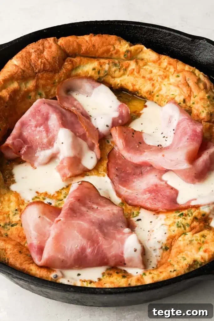Savory Dutch Baby savory dutch baby with ham and bechamel sauce in a skillet
