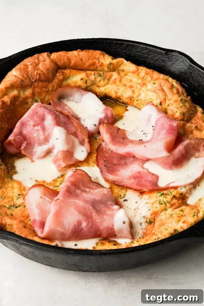 best savory dutch baby recipe savory dutch baby with ham and bechamel sauce in a skillet