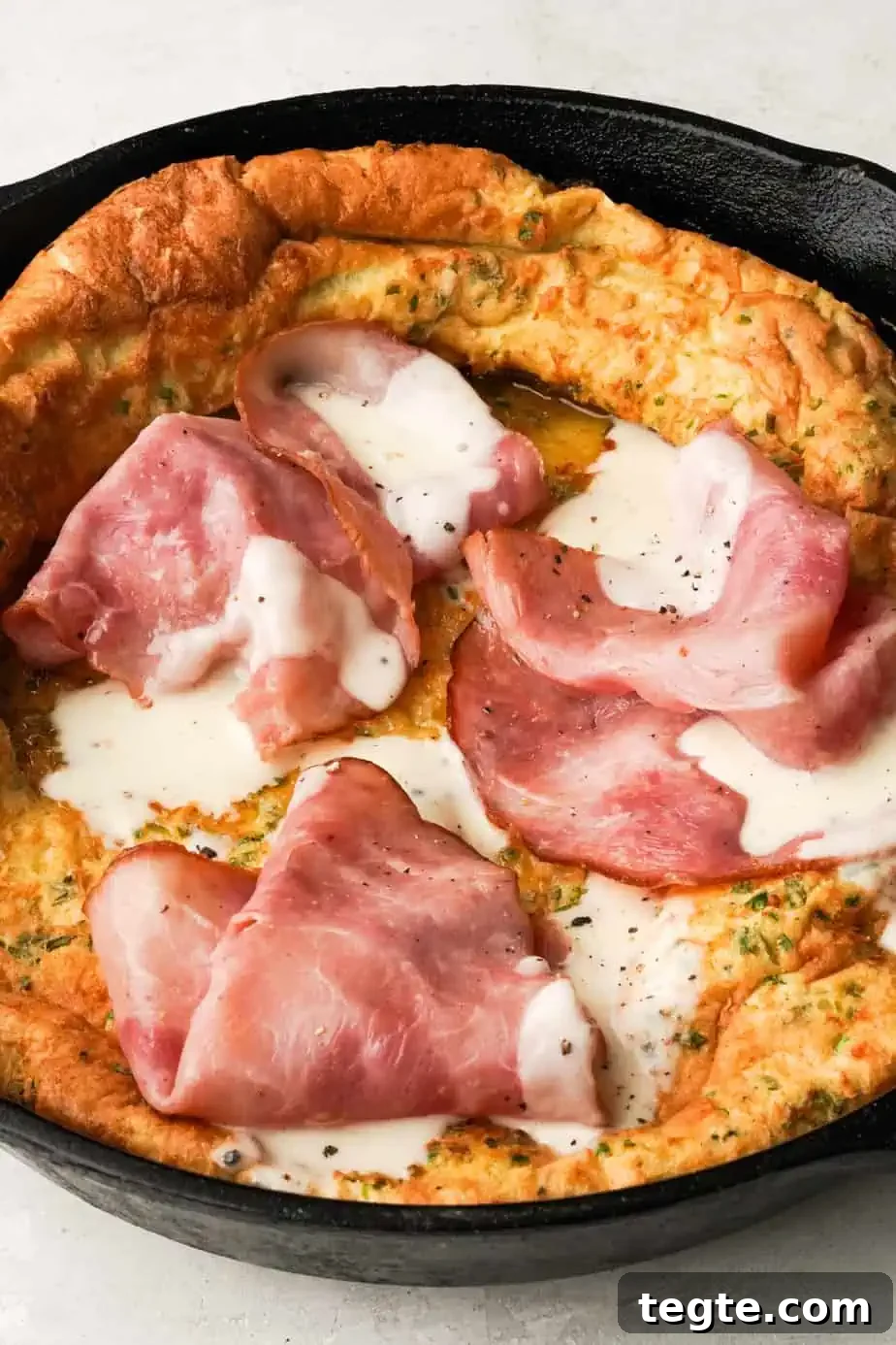 Savory Dutch Baby Croque Monsieur Recipe: Classic French Brunch 5 savory dutch baby with ham and bechamel sauce in a skillet
