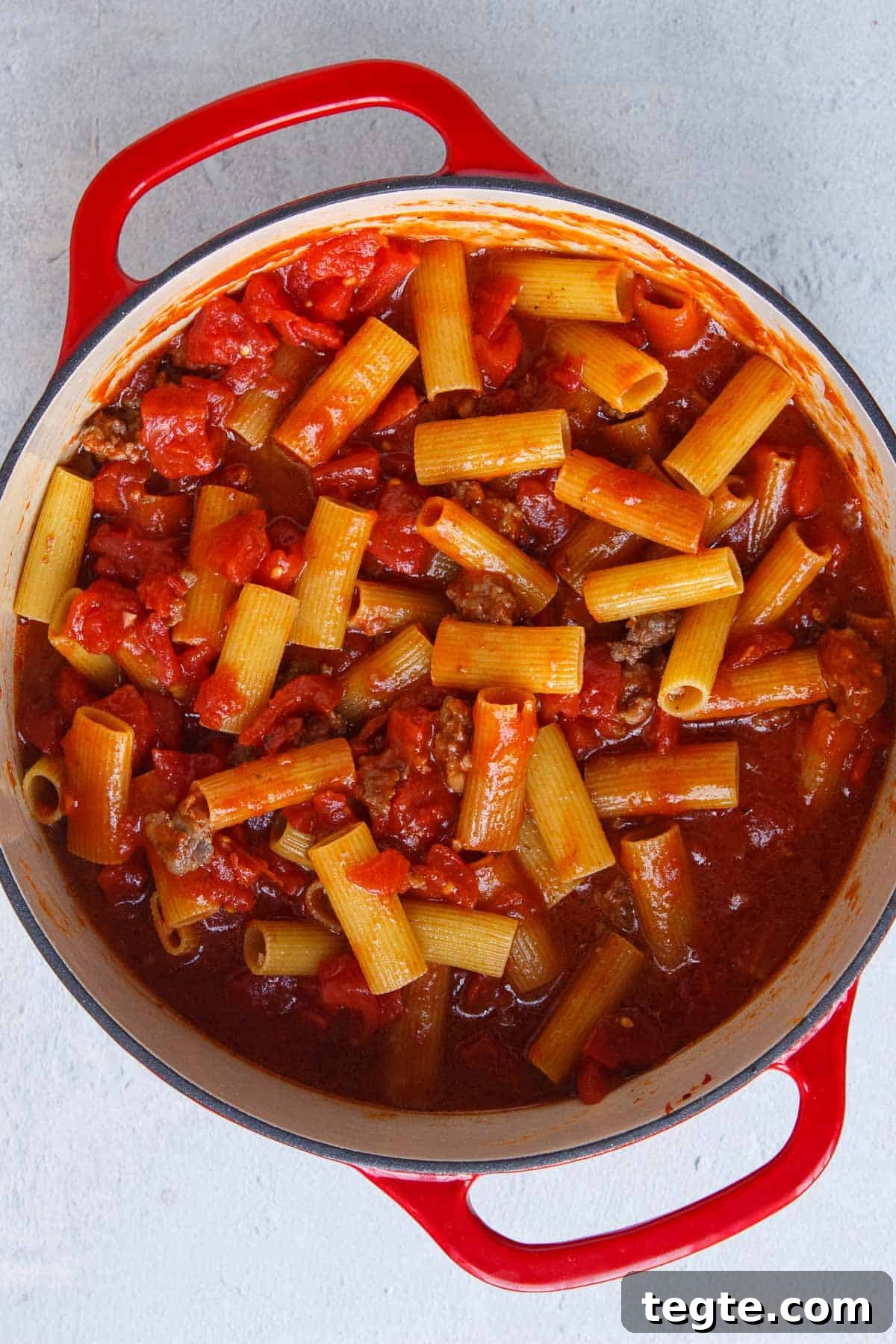 Uncooked rigatoni in meat sauce
