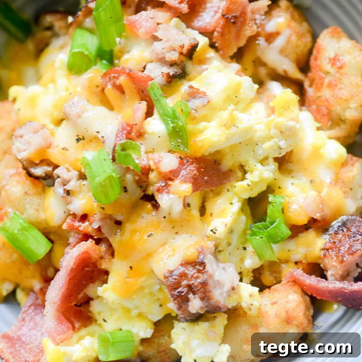 Hearty Country Breakfast Bowl Recipe for Morning Energy 2 Country Breakfast Bowl - a hearty breakfast bowl topped with scrambled eggs, bacon, sausage and melted cheese on top!