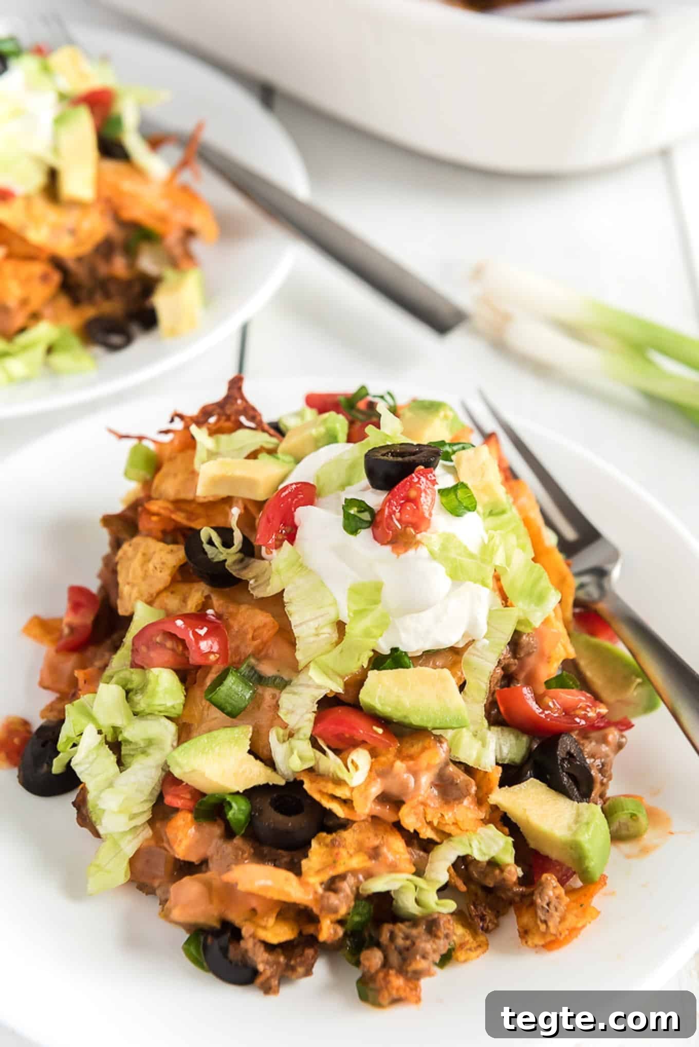 Doritos Taco Casserole: Cheesy Tex-Mex Bake Everyone Loves 2 Slice of Doritos taco casserole on a plate.