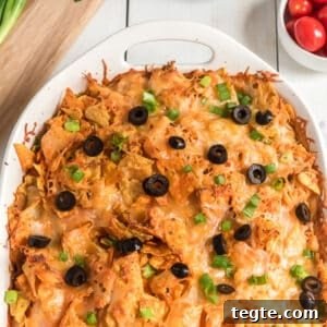 Doritos Taco Casserole: Cheesy Tex-Mex Bake Everyone Loves 11 Baked taco casserole with Dorritos in a pan.