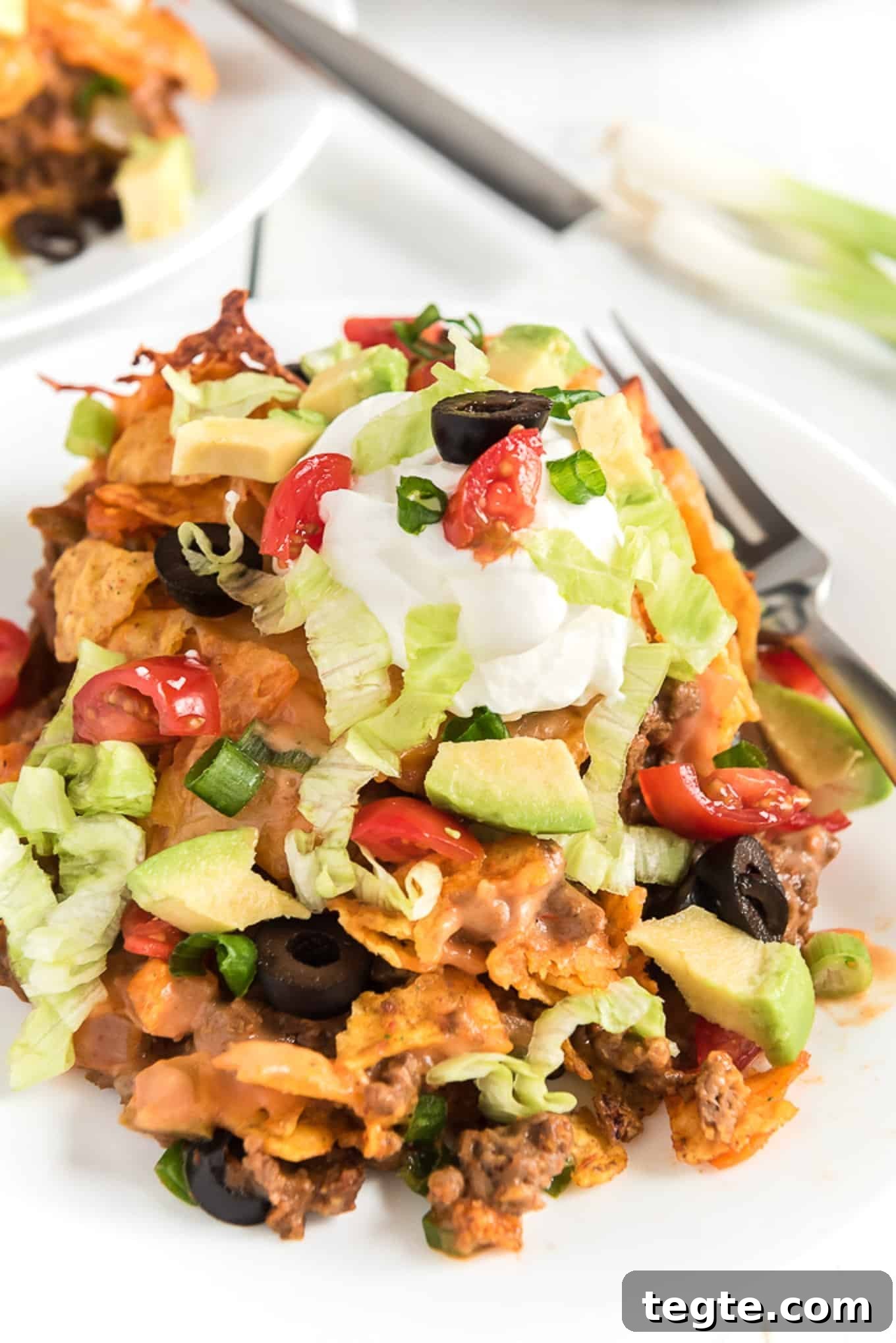 Doritos Taco Casserole: Cheesy Tex-Mex Bake Everyone Loves 6 Slice of Dorito taco casserole on a plate.