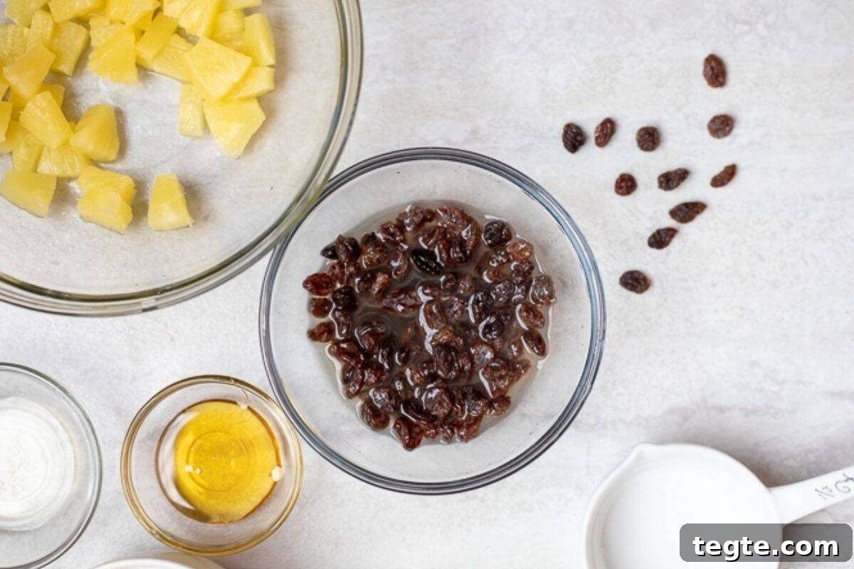 Healthy Carrot Raisin Salad Raisins soaking in pineapple juice.