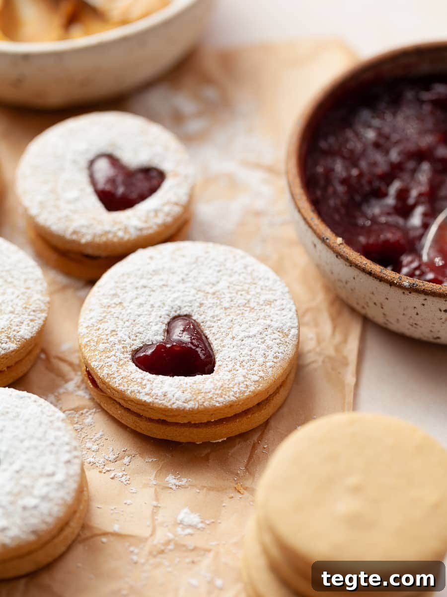 Gluten-Free Peanut Butter & Jelly Cookies Recipe 2 Gluten Free Peanut Butter And Jelly cookies with raspberry jam and creamy peanut butter