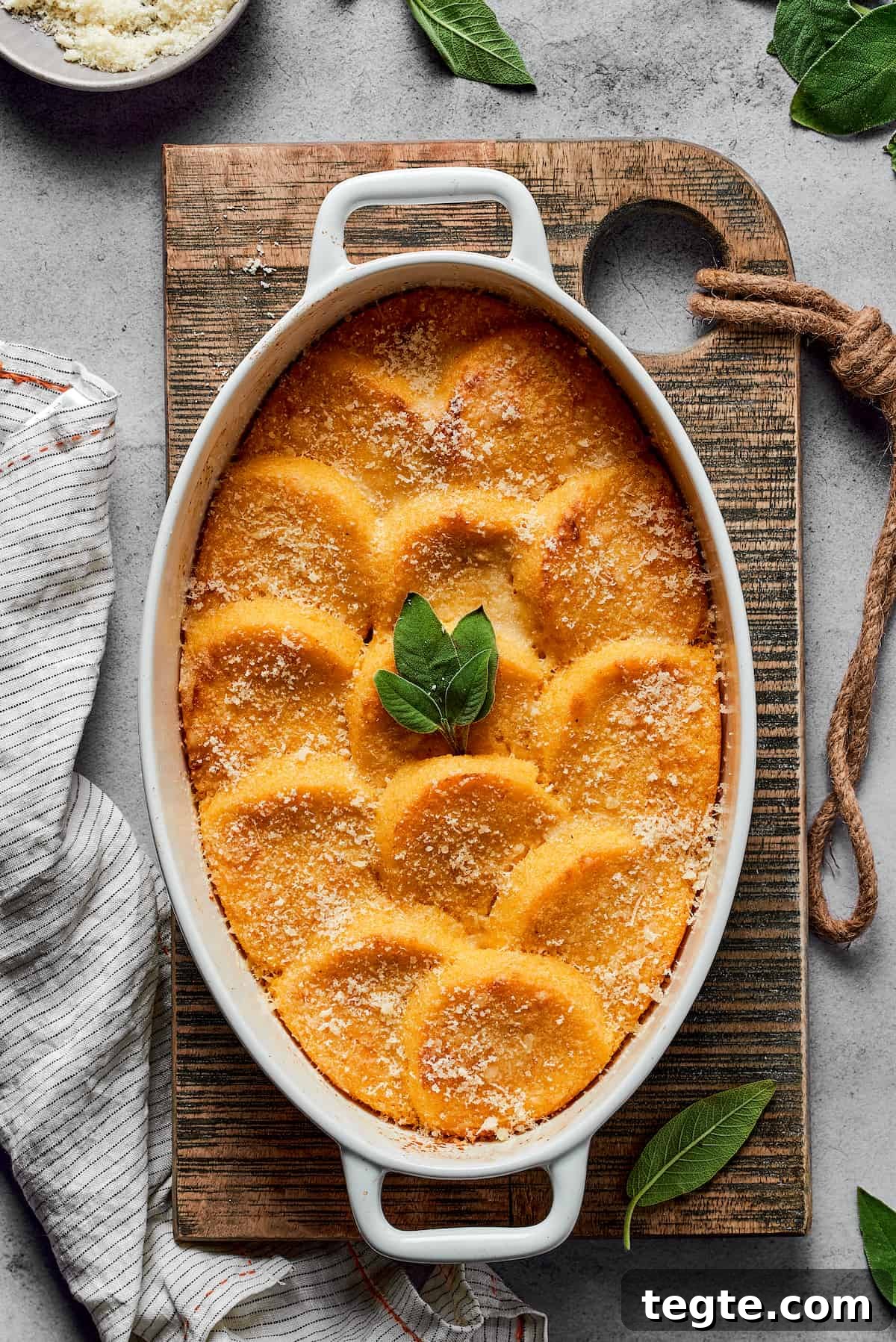 Baked gnocchi alla Romana garnished with fresh sage.