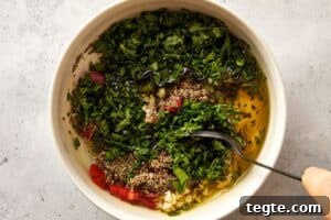 Top overview of chimichurri being mix in a white surface