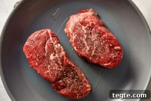 Top overview of raw beef in a skillet