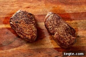resting cooked steak on a cutting board before slicing for salad