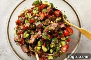 tossed steak chickpea salad with chimichurri in a bowl
