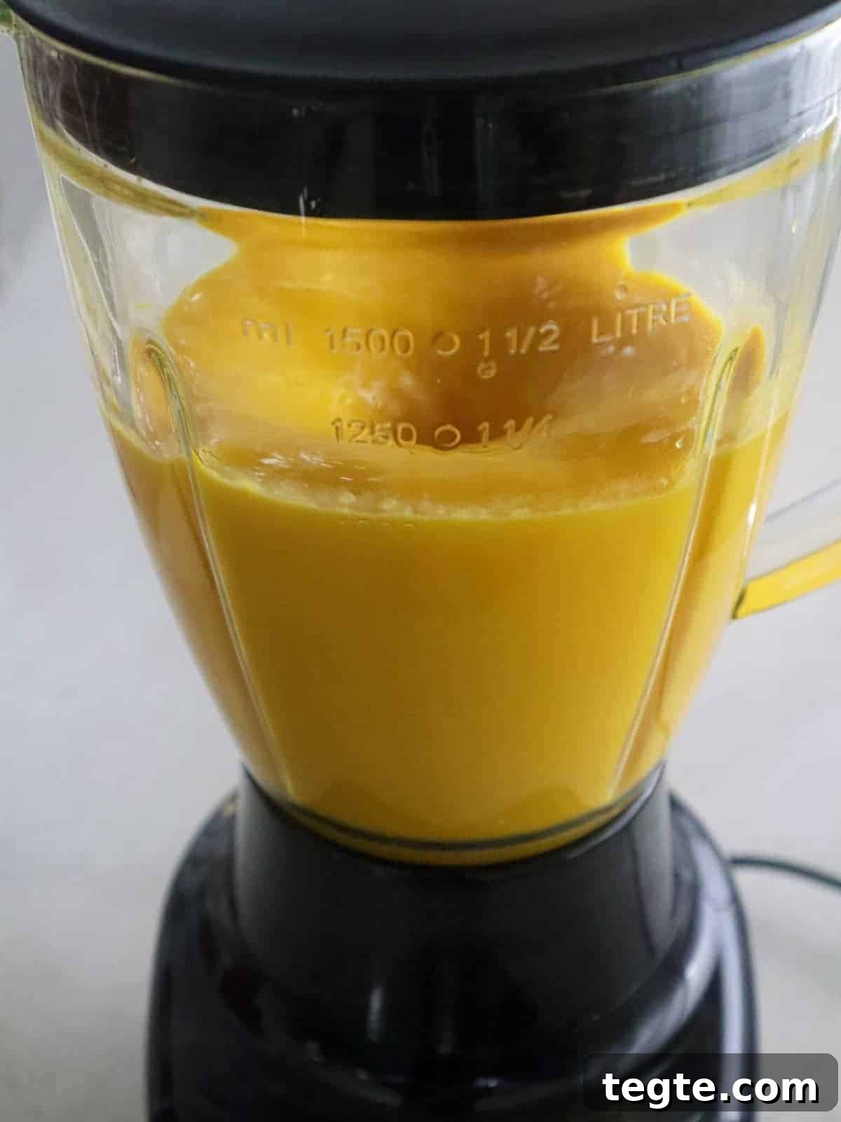 Homemade Mango Nectar Recipe: Smooth, Fresh Mango Drink 5 pureeing mango in a blender