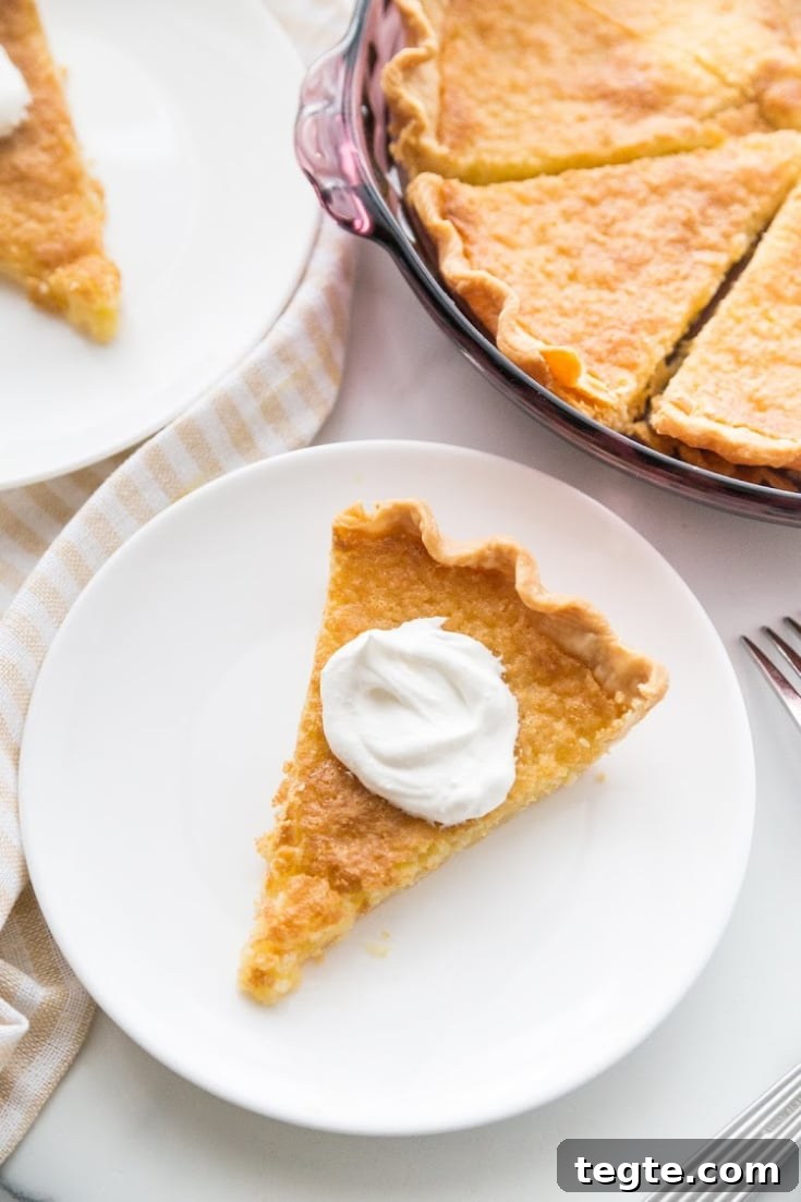 Southern Buttermilk Pie Recipe — Quick 30-Minute Dessert 6 a slice of pie with a dollop of whip cream on the top