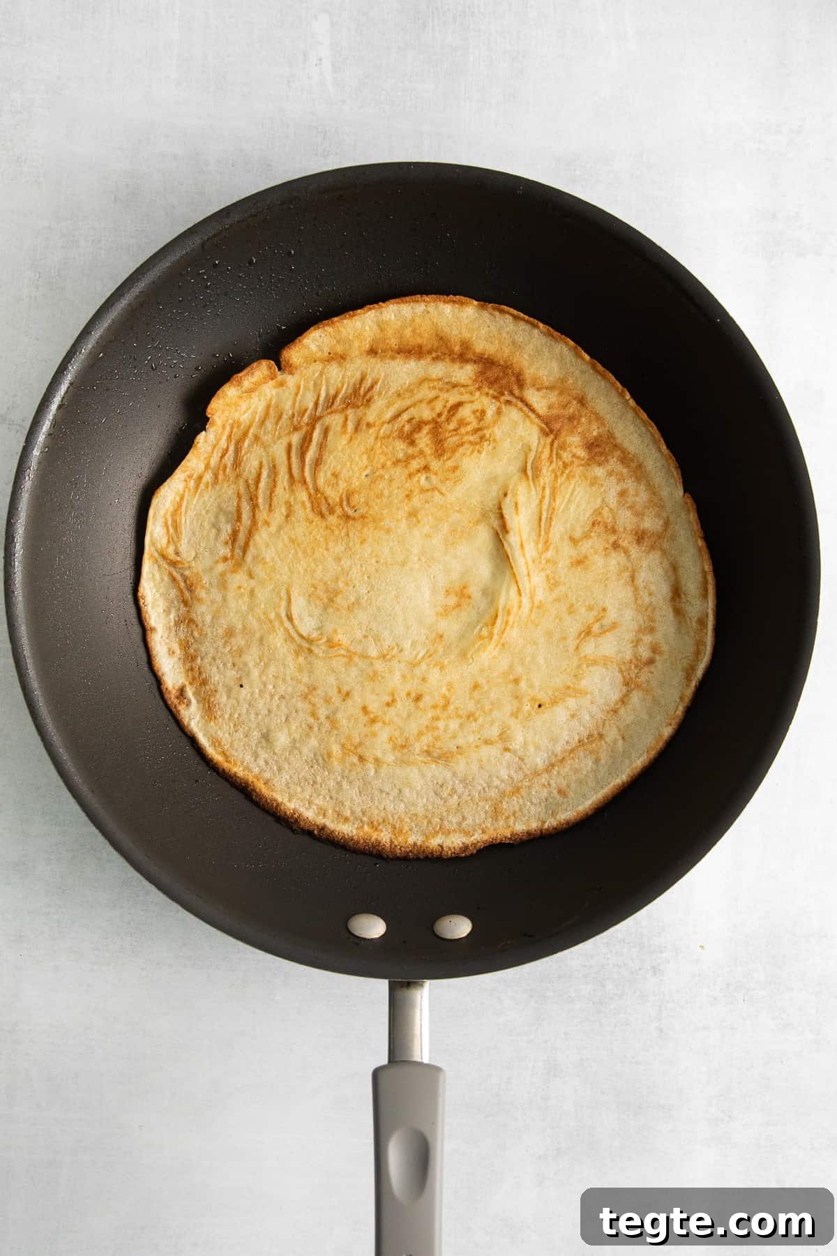 Goat cheese crepe in a skillet. Goat cheese crepe in a skillet.