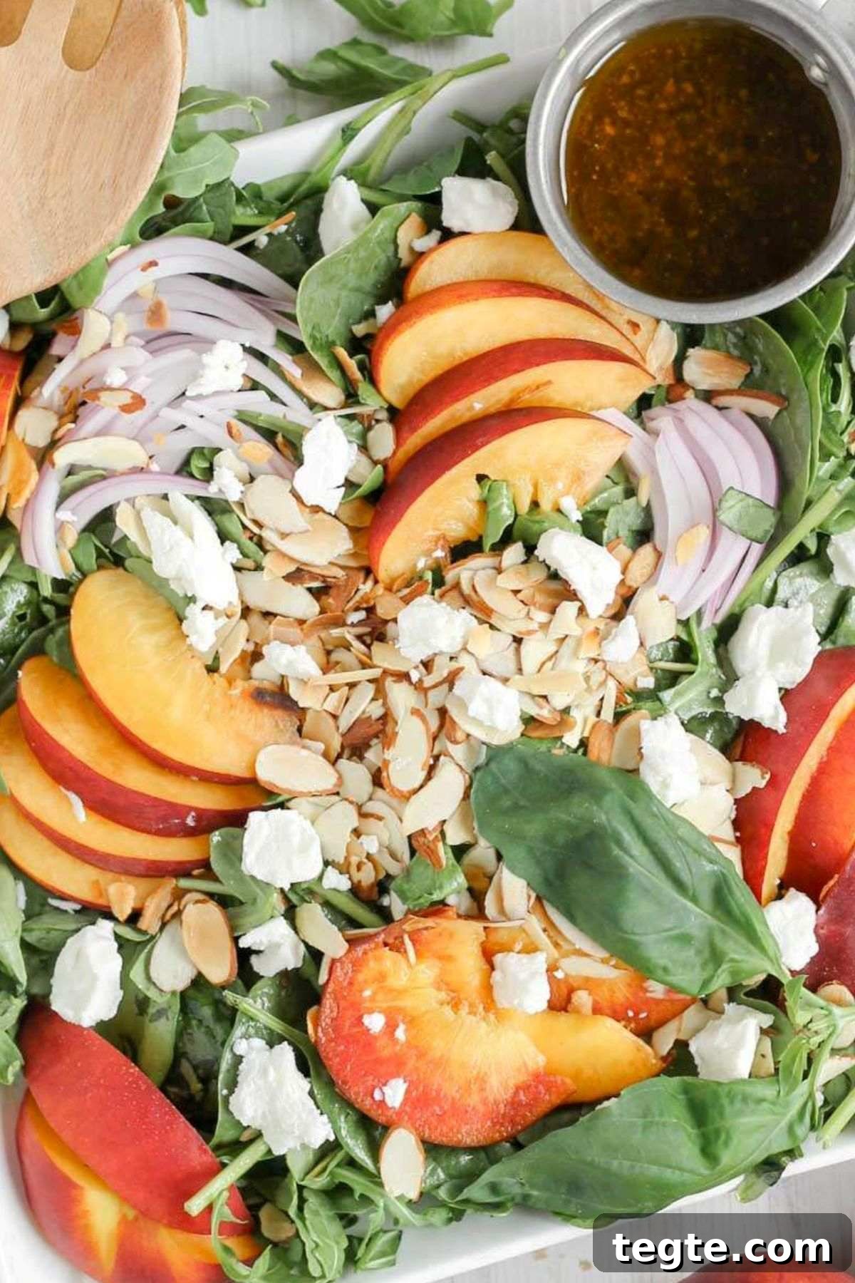 Mixed greens topped with sliced peaches, slivered almonds, red onion slices, goat cheese crumbles with a side of vinaigrette dressing.