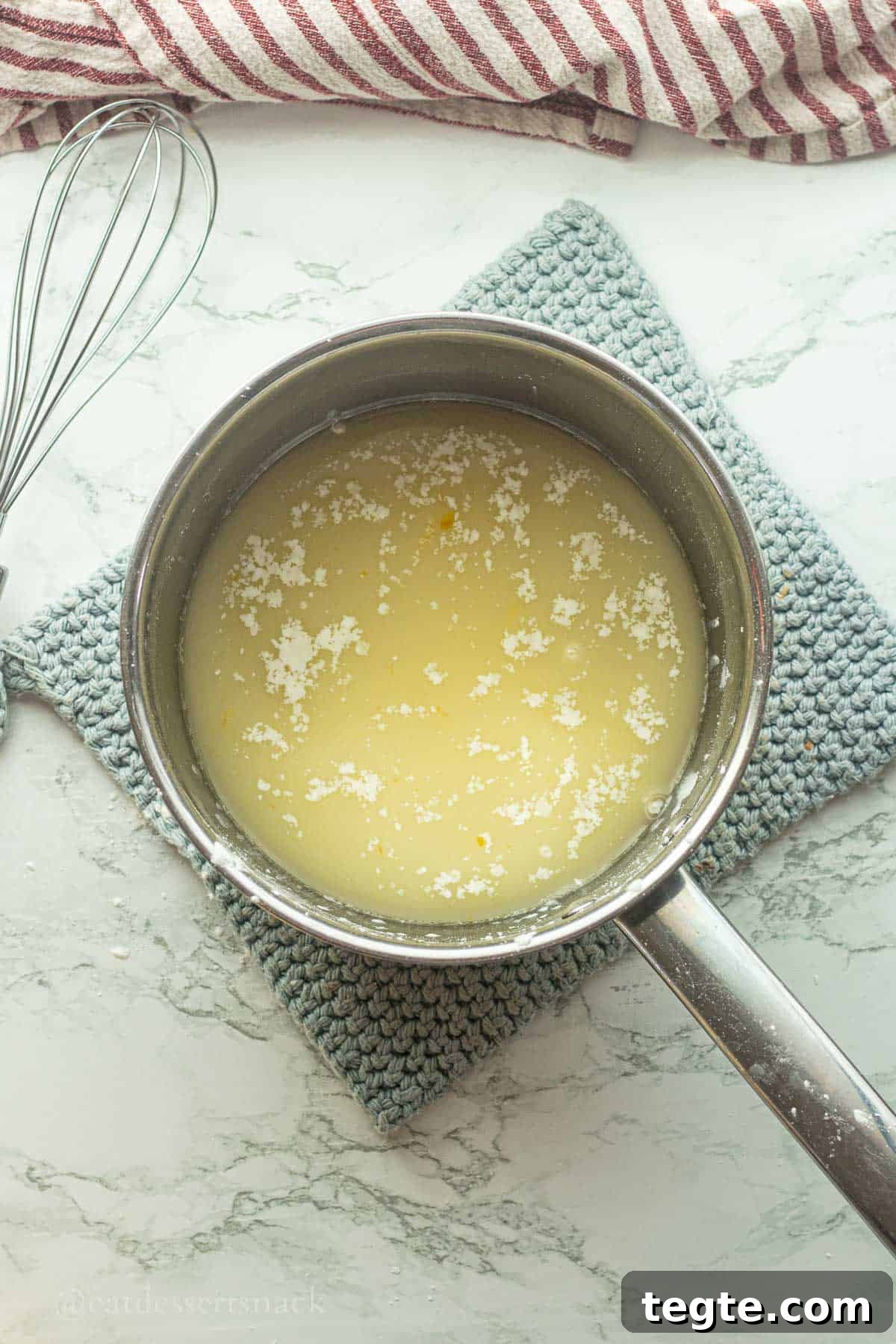 Pineapple and orange juice and cornstarch in pot.