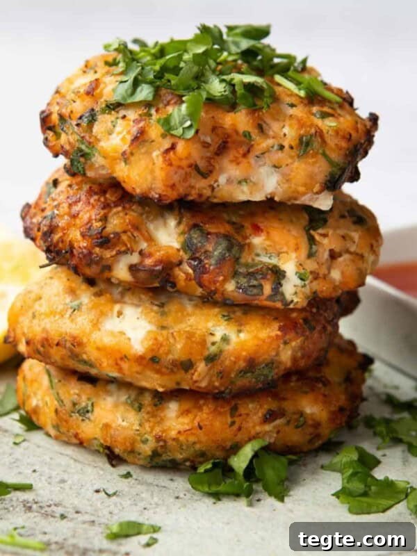 Crispy Salmon Burgers with Lemon-Dill Sauce 11 Sweet Chilli Salmon Fishcakes stacked on top of each other, topped with coriander
