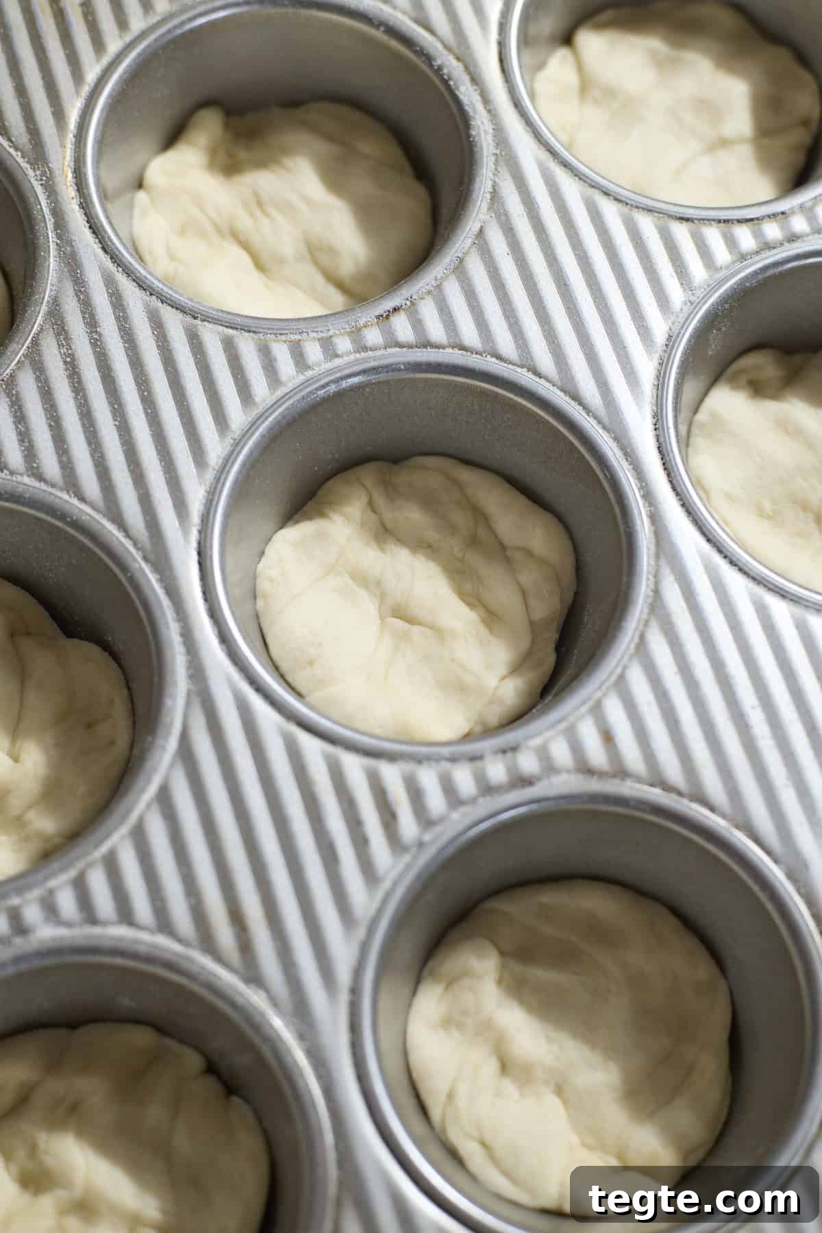 Mini Sourdough Discard Pizzas: Crispy Tiny Pizzas from Leftover Starter 7 Dough pressed into the muffin pan.