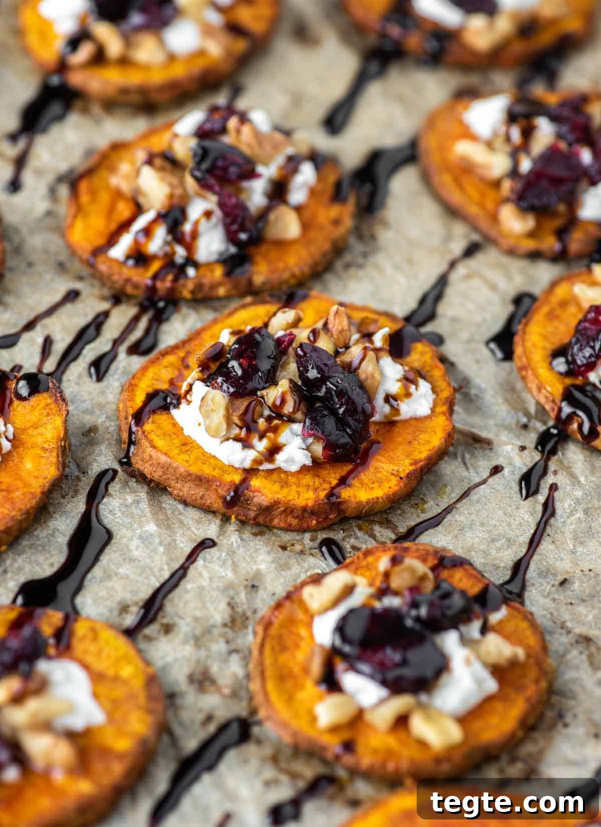 close-up of sweet potato rounds with goat cheese, walnuts, cranberries and balsamic vinegar