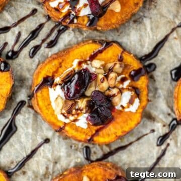 overhead shot of sweet potato rounds with goat cheese, walnuts, cranberries and balsamic vinegar