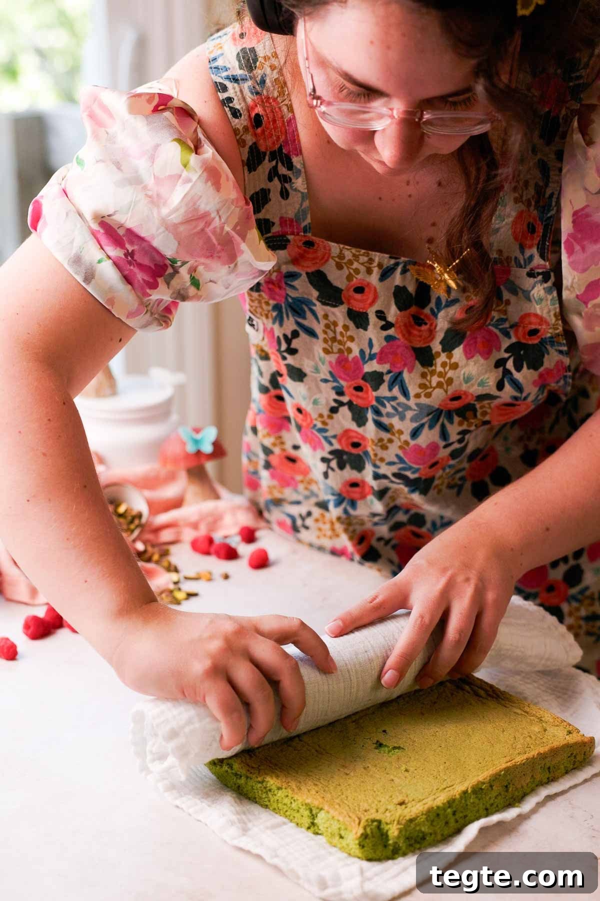Raspberry and Pistachio Cake Roll Recipe for Spring Gatherings 8 rolling pistachio sponge in kitchen towel