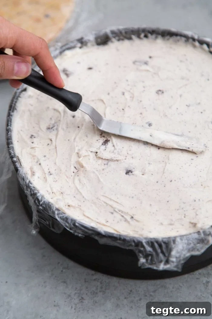 Cookies and Cream Ice Cream Cake Recipe for Rich, No-Bake Dessert 5 Layered ice cream cake smooth out with mini offset spatula.