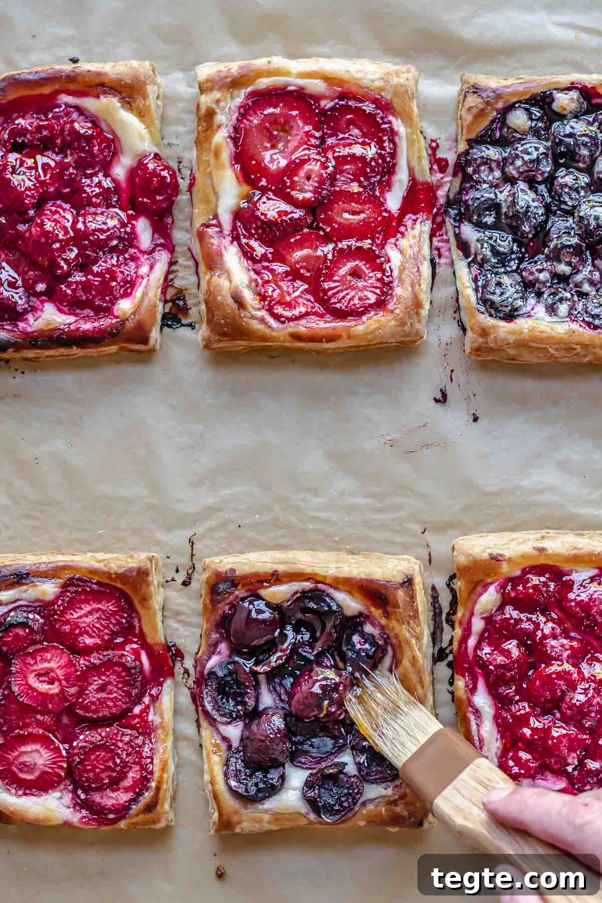 Fruit and Cream Cheese Danish with Flaky Puff Pastry 12 A pastry brush brushes on fruit spread to the baked danish.