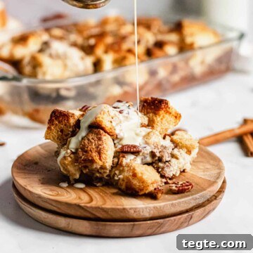 Bourbon sauce being poured onto the bread pudding