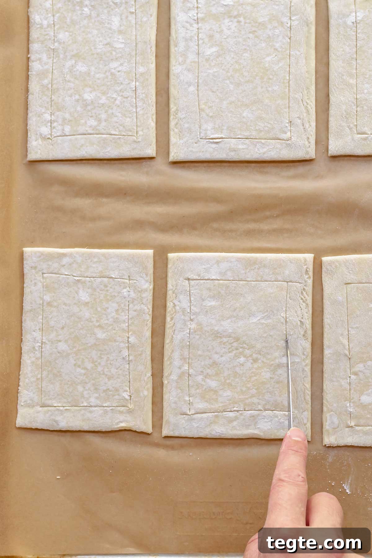 Fruit and Cream Cheese Danish with Flaky Puff Pastry 7 The tip of a knife scoring borders on the puff pastry pieces.