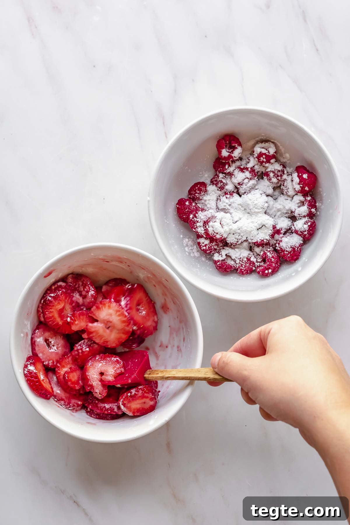 Fruit and Cream Cheese Danish with Flaky Puff Pastry 9 A spatula mixes fruit and cornstarch in bowls.