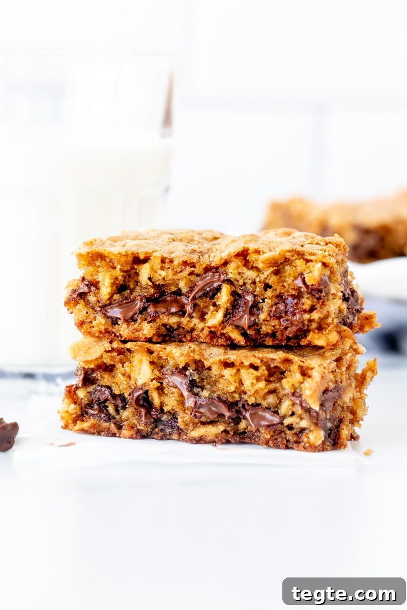 Chewy Oatmeal Chocolate Chip Cookie Bars Recipe 7 Oatmeal chocolate chip cookie bar broken in half with glass of milk