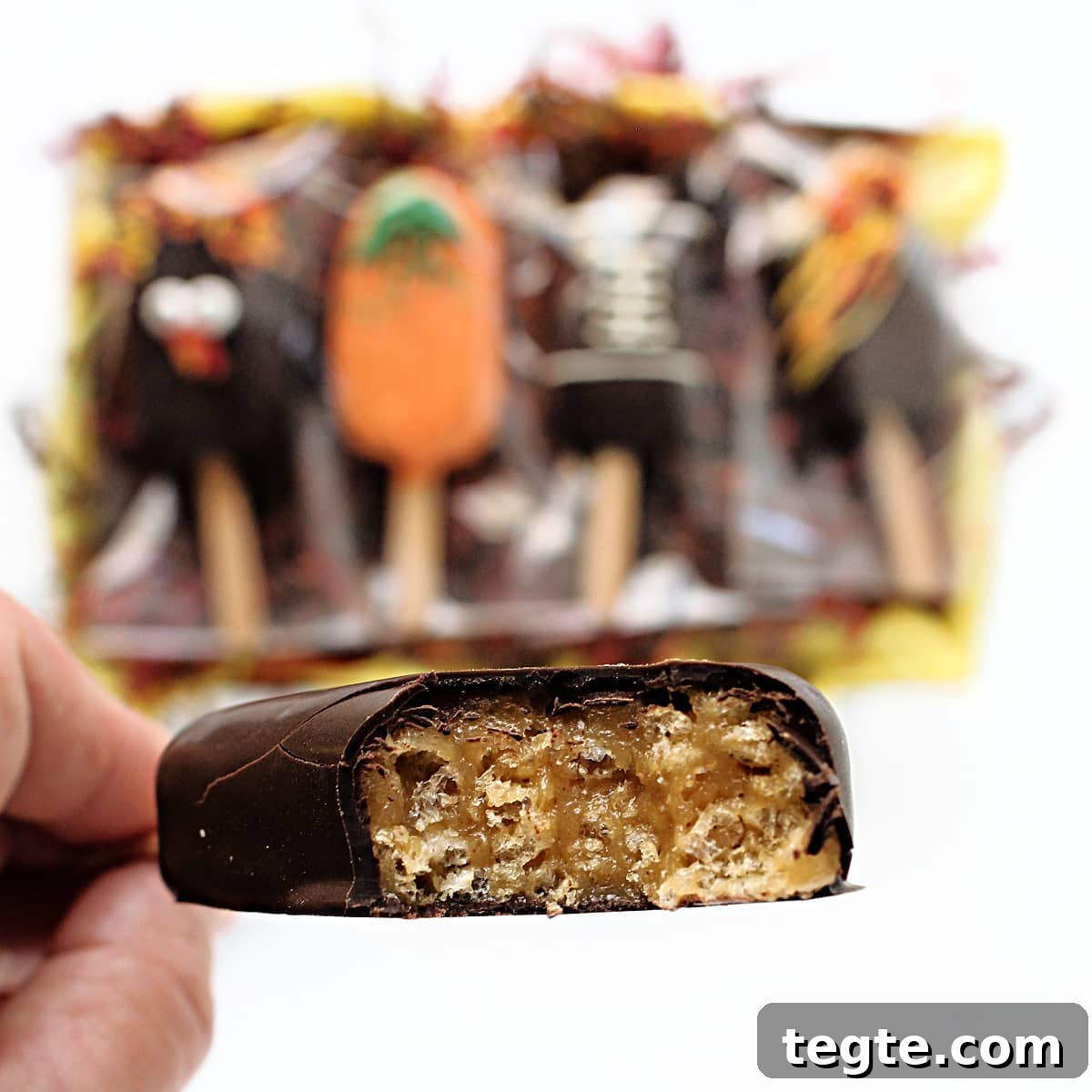 Thanksgiving Peanut Chew Candy Pops Recipe for Fall Treats 9 Closeup of pop with a bite taken to show chewy interior.