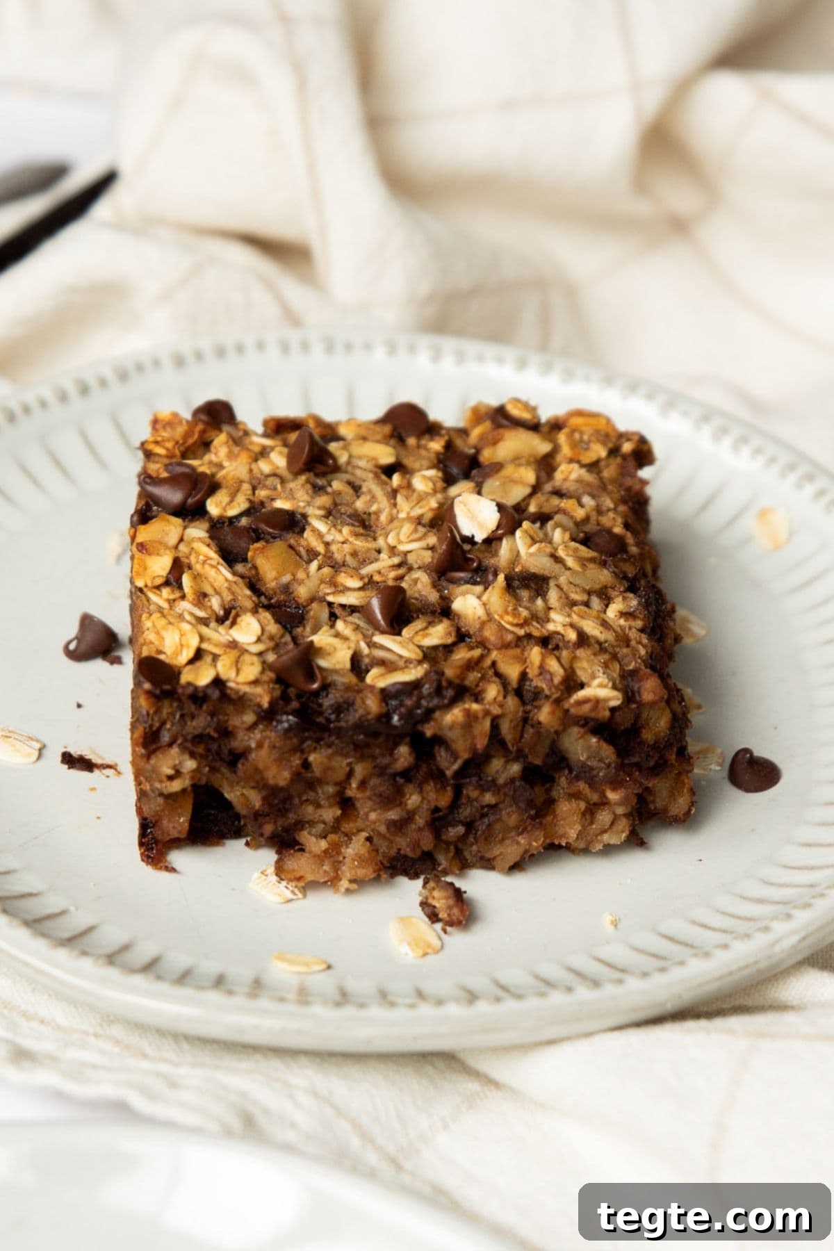Vegan Baked Oatmeal Recipe for Busy Mornings 2 Moist and soft vegan oatmeal bake with gooey chocolate chips.