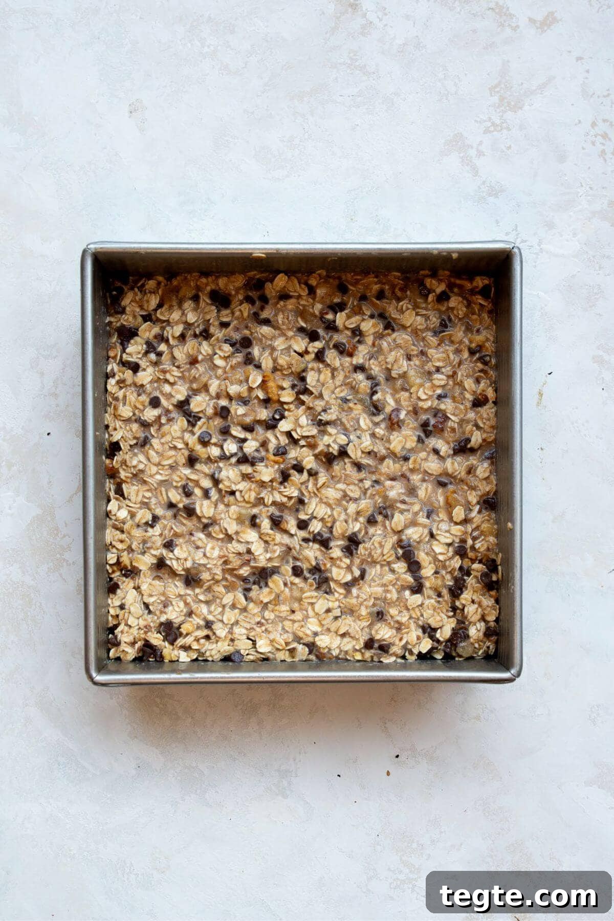 Vegan Baked Oatmeal Recipe for Busy Mornings 7 Uncooked vegan baked oatmeal in a baking dish.