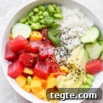 A tuna poke bowl with sushi rice, tuna, mango and avocado.