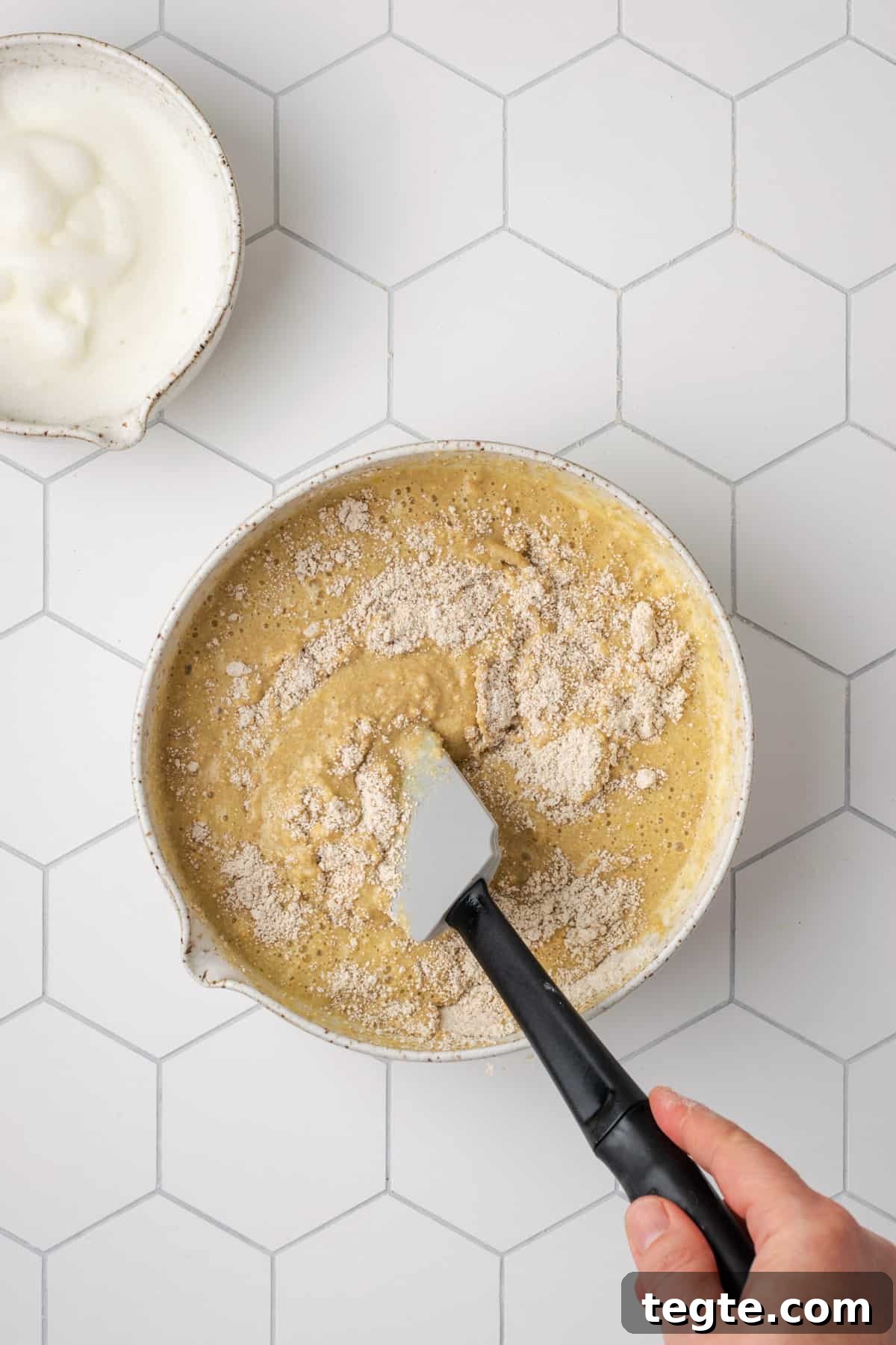 Crispy Oat Flour Waffles Recipe - Fluffy & Gluten-Free Option 12 Wet and dry ingredients being folded together with a spatula.