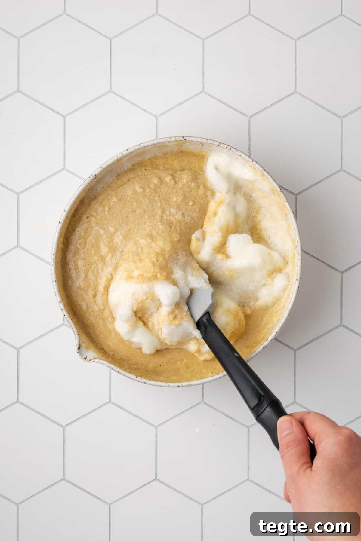 Crispy Oat Flour Waffles Recipe - Fluffy & Gluten-Free Option 13 Egg white foam being folded into the waffle batter.